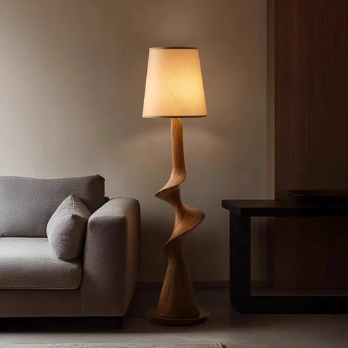 Modern floor lamp with a wooden base in a living room setting.