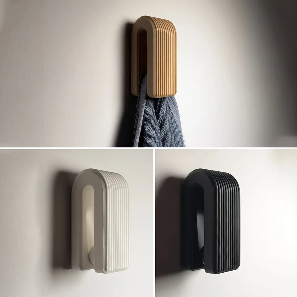 Wall hooks in various colors on a plain background