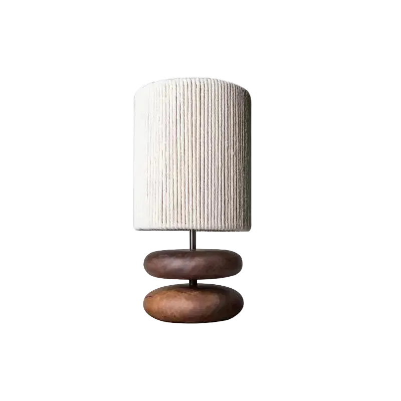 Table lamp with a textured white shade and wooden base on a white background