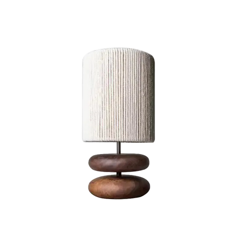 Table lamp with a textured white shade and wooden base on a white background